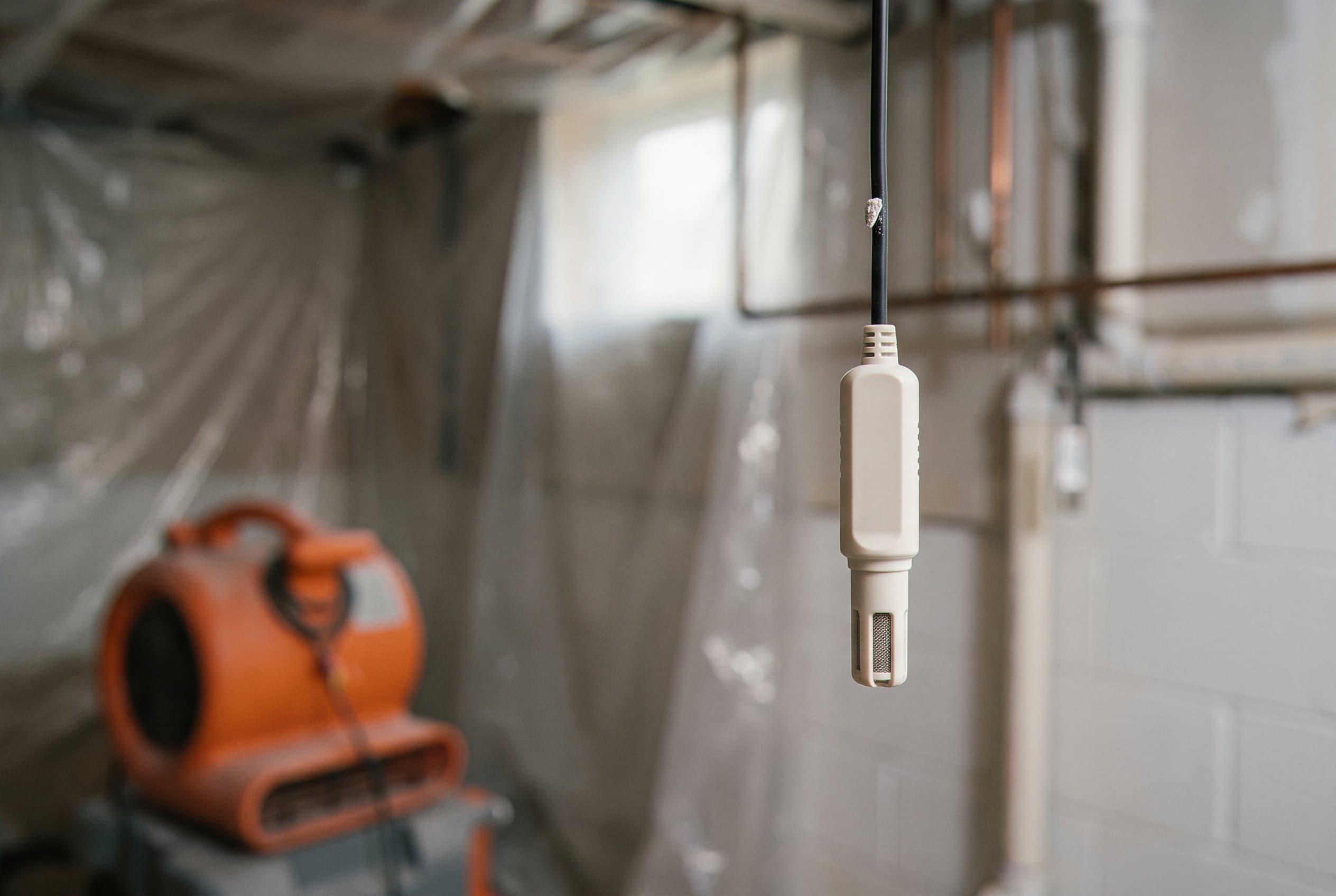 Moisture meter measuring water content inside wall cavity